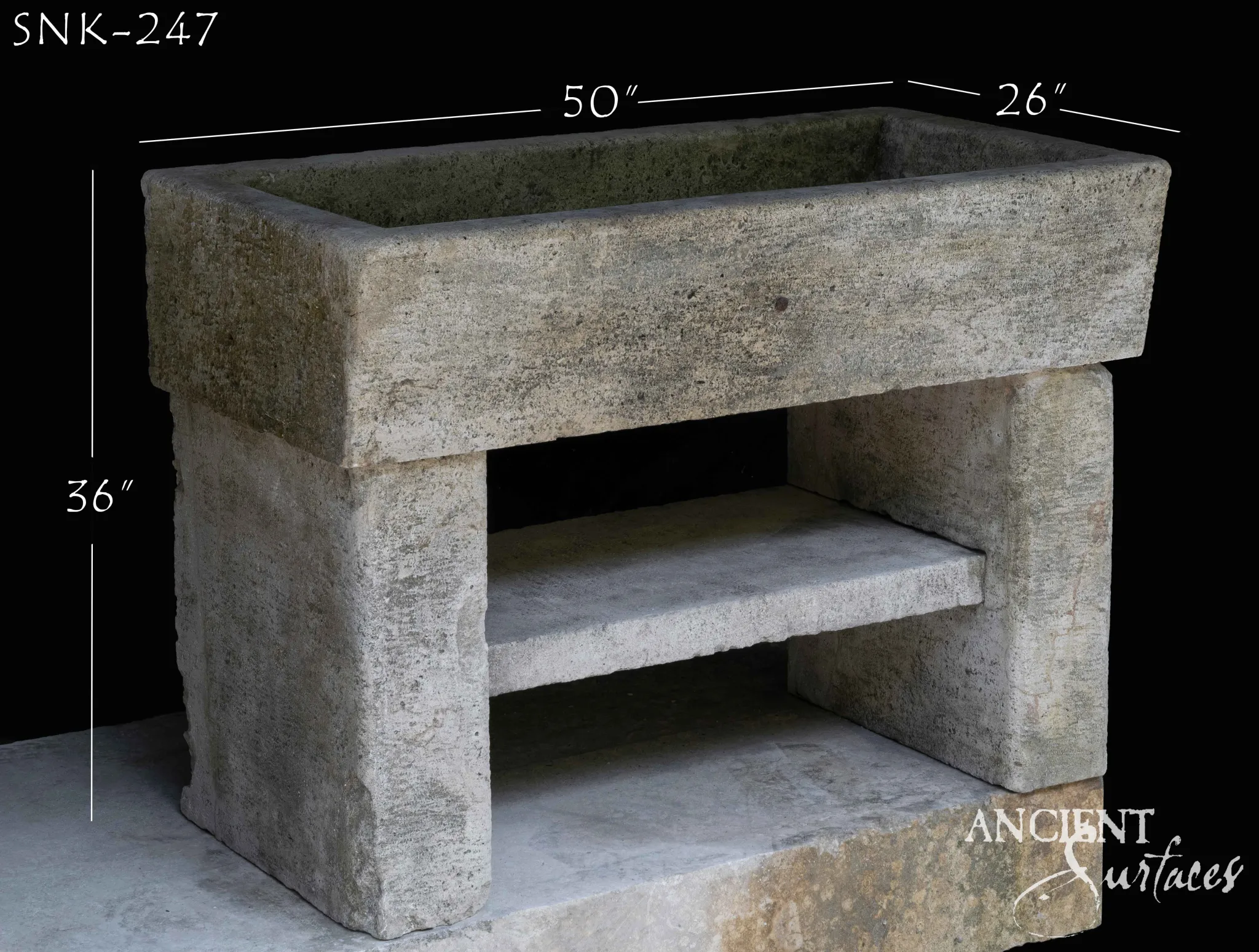 Weathered grey reclaimed limestone trough sink with thick plain walls standing on an open two pier stone base with a shelf slab