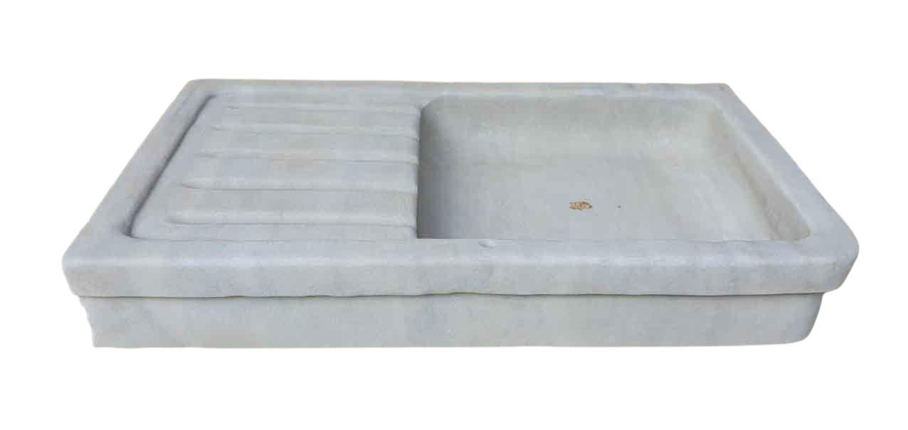 Wide reclaimed stone sink with a ribbed draining board on the left and an open rectangular basin on the right